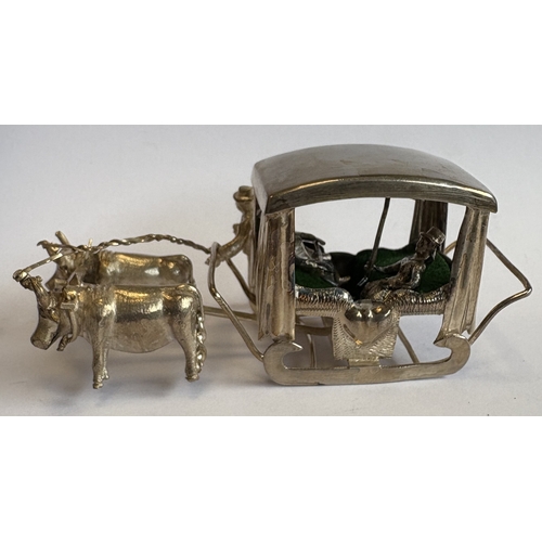 12 - A heavy Continental silver table toy in the form of a bull ridden carriage. Approx. 60 grams. Est. £... 