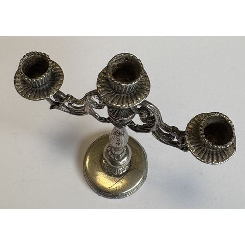 14 - A Continental silver table toy in the form of a candelabra. Approx. 38 grams. Est. £30 - £50.
