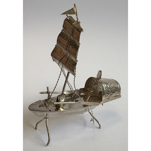 155 - A small novelty silver model of a junk on stand. Approx. 7 grams. Est. £20 - £30.