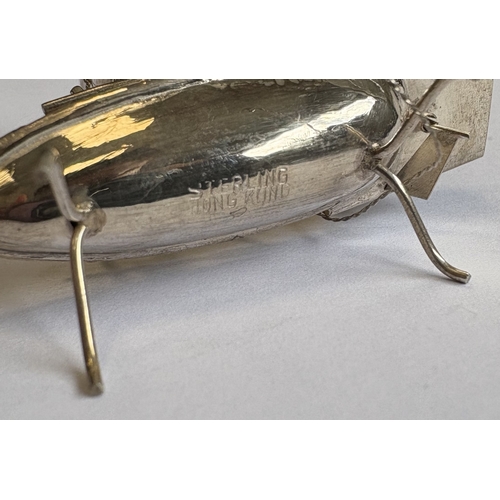 155 - A small novelty silver model of a junk on stand. Approx. 7 grams. Est. £20 - £30.