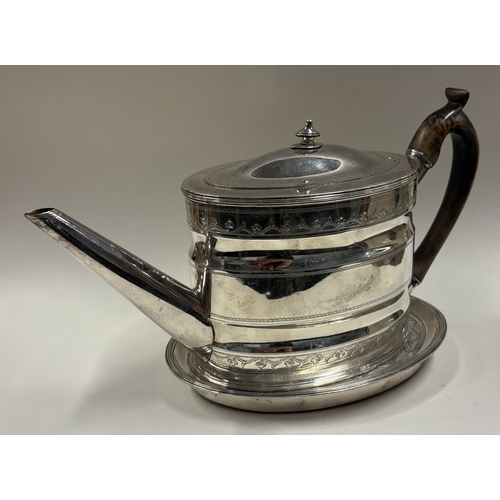 159 - An 18th Century George III silver teapot with bright-cut decoration on stand. London 1791. By Robert... 