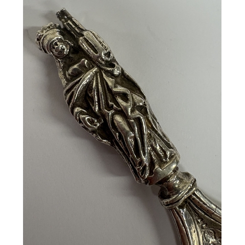 17 - A Victorian silver caddy spoon with embossed scene to centre. Bearing English import marks. Sheffiel... 