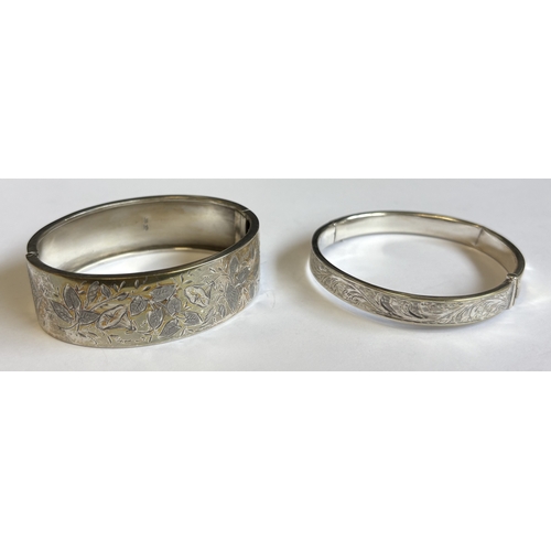 178 - Two engraved silver bangles. Approx. 34 grams. Est. £20 - £30.