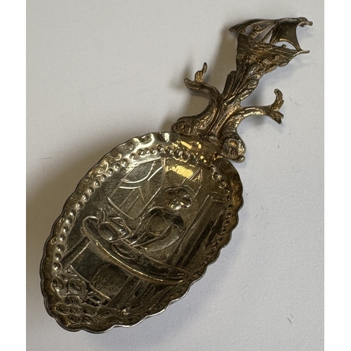 180 - A heavy cast silver caddy spoon with scroll decoration. Approx. 30 grams. Est. £20 - £30.