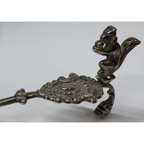 20 - An Antique Continental silver caddy spoon with cast squirrel to handle and embossed scene to bowl. A... 