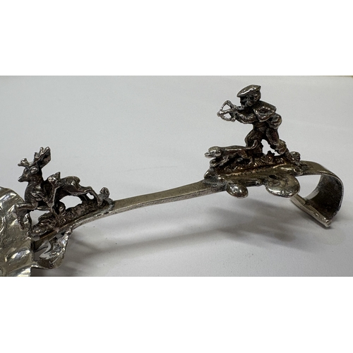 22 - A rare Antique Continental silver caddy spoon cast with man with dog shooting stag. Approx. 31 grams... 