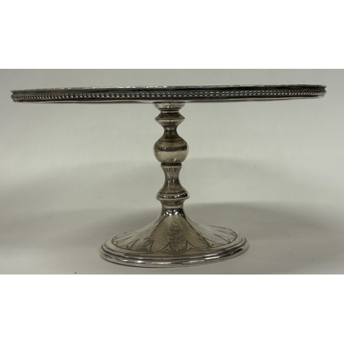 38 - A Modernistic silver tazza with unusual bright-cut decoration to top. London 1977. By Kenneth Bagule... 