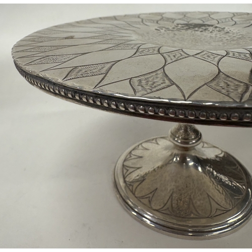 38 - A Modernistic silver tazza with unusual bright-cut decoration to top. London 1977. By Kenneth Bagule... 