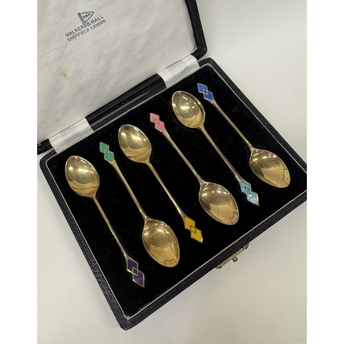 39 - A set of six silver gilt and enamelled spoons. Birmingham 1921. By Walker & Hall. Approx. 35 grams. ... 