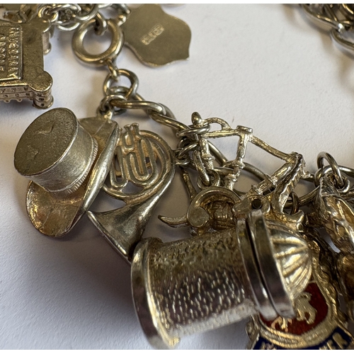 42 - A heavy silver curb link charm bracelet. Approx. 70 grams. Est. £40 - £60.