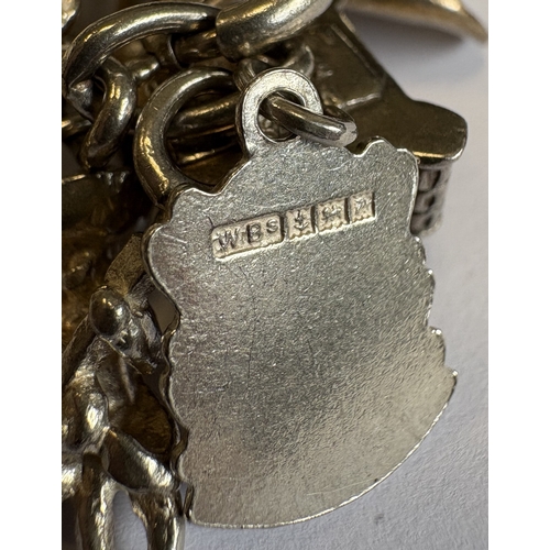 42 - A heavy silver curb link charm bracelet. Approx. 70 grams. Est. £40 - £60.