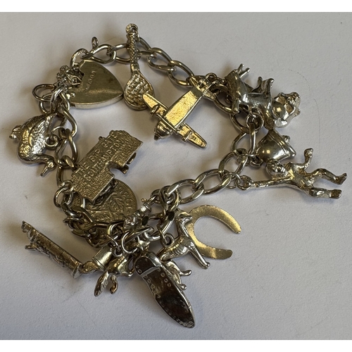 43 - A silver curb link charm bracelet with heart-shaped padlock. Approx. 42 grams. Est. £30 - £40.