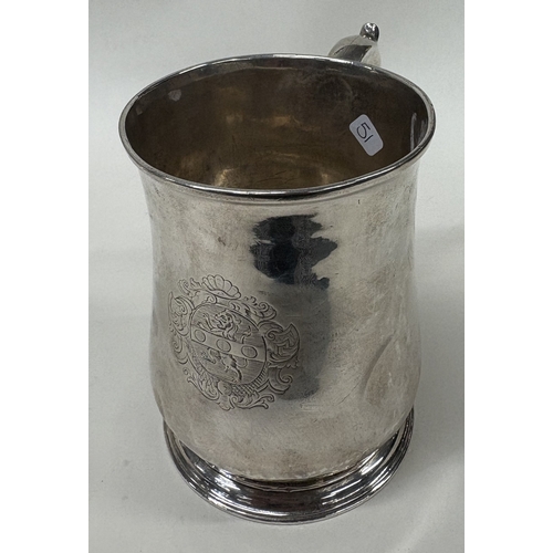 51 - A large 18th Century silver pint mug with coat of arms to centre. London 1732. By Thomas Mason. Appr... 