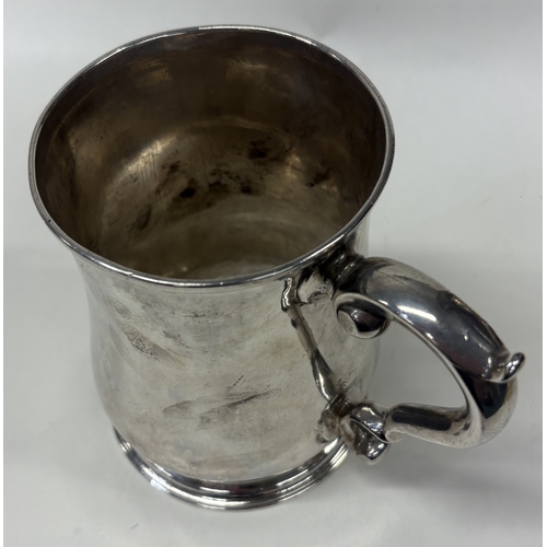 51 - A large 18th Century silver pint mug with coat of arms to centre. London 1732. By Thomas Mason. Appr... 