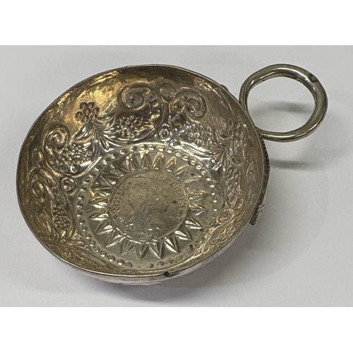 56 - A French silver wine taster with coin to centre. Marked to handle. Circa 1800. Approx. 28 grams. Est... 