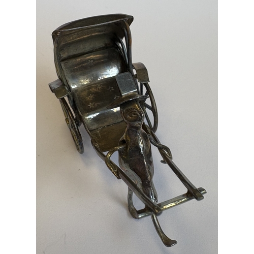 60 - An unusual miniature silver model of a rickshaw. Approx. 29 grams. Est. £30 - £50.