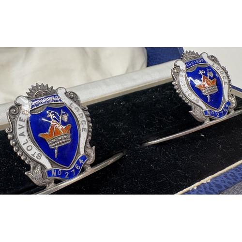 7 - A cased pair of Masonic silver and enamelled 'St. Olaves Lodge' menu holders . Birmingham 1931. By J... 