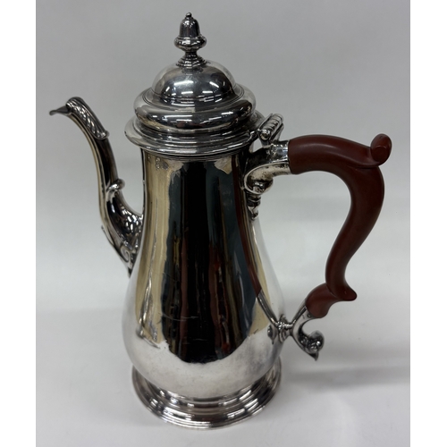 86 - A George III silver coffee pot with crested decoration. London 1756. By Richard Gurney & Thomas Cook... 