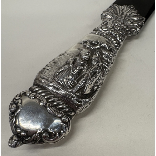 9 - A large Victorian silver and faux tortoiseshell letter opener with embossed decoration to handle. Lo... 