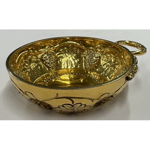 210 - A modernistic silver-gilt wine taster embossed with vines. London 1973. By CJ Vander. Approx. 101 gr... 