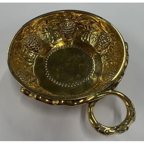 210 - A modernistic silver-gilt wine taster embossed with vines. London 1973. By CJ Vander. Approx. 101 gr... 
