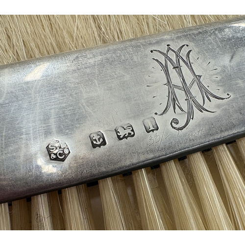 197 - A pair of silver-mounted crumb brushes contained within original pouch. Birmingham 1910. By SB & Co.... 