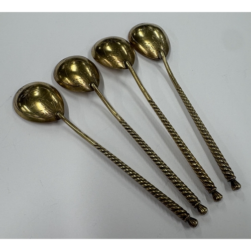 201 - A set of four Russian silver-gilt ice cream spoons with engraved floral decoration. Approx. 63 grams... 