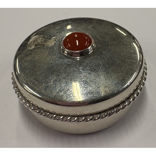 422 - A silver snuff box with lift-off cover decorated with red stone, engraved with bee decoration to bas... 