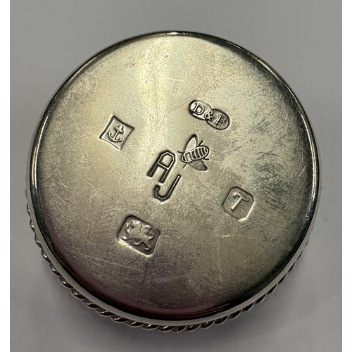 422 - A silver snuff box with lift-off cover decorated with red stone, engraved with bee decoration to bas... 