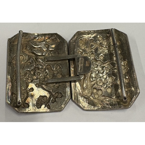 445 - A 19th Century Chinese export silver buckle with chased repousse decoration. Approx. 22 grams. Est. ... 