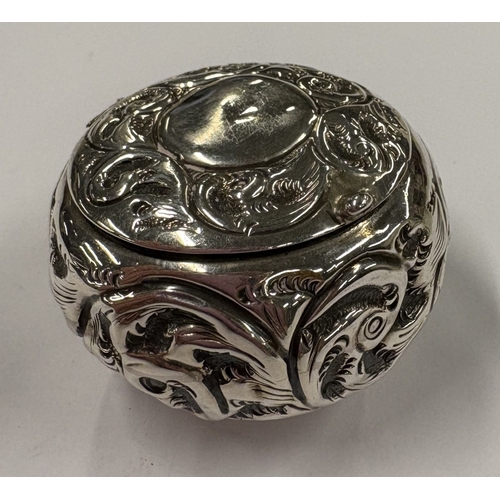 454 - An embossed silver pill box with hinged cover. Birmingham 1901. Approx. 13 grams. Est. £20 - £30.