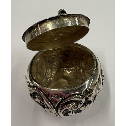 454 - An embossed silver pill box with hinged cover. Birmingham 1901. Approx. 13 grams. Est. £20 - £30.