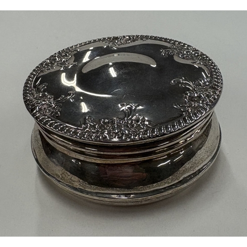 455 - A silver box with embossed decoration to hinged cover. Approx. 80 grams. Est. £80 - £120.