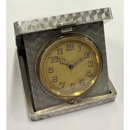 461 - A heavy silver combination clock and cigarette case with engine-turned decoration. Birmingham 1928. ... 