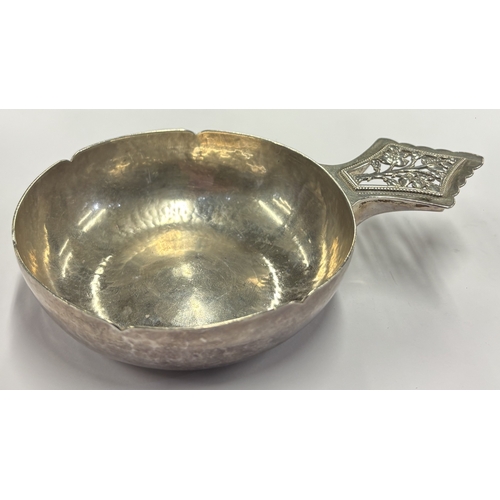 464 - A silver wine taster with 'Tree of Life' decoration to handle. London 1929. By Henry George Murphy. ... 