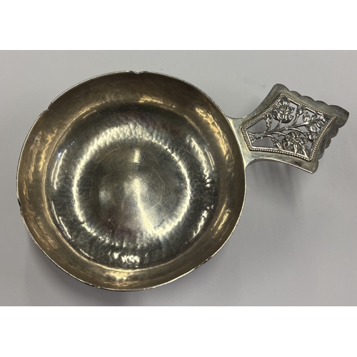 464 - A silver wine taster with 'Tree of Life' decoration to handle. London 1929. By Henry George Murphy. ... 