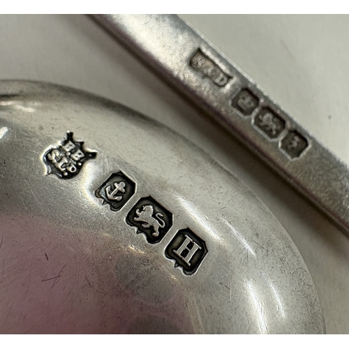 476 - A silver nail top spoon. Sheffield. By Roberts & Dore Ltd. Together with a silver spoon with golf cl... 