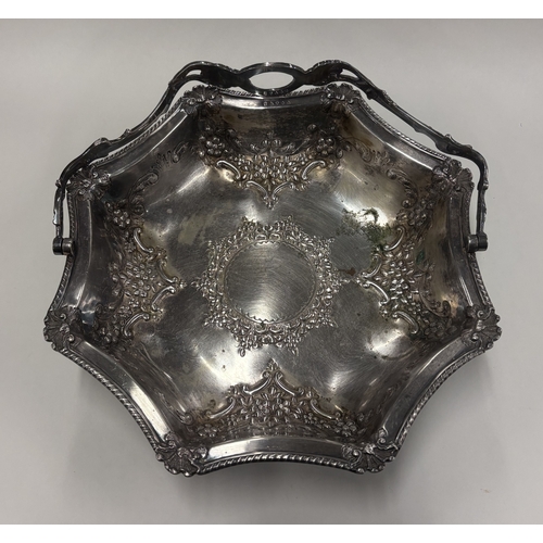 544 - A silver-plated swing-handled basket. Est. £10 - £20.