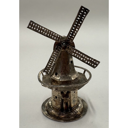 561 - A silver model of a Dutch windmill. Approx. 35 grams. Est. £30 - £40.