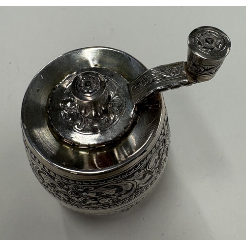 564 - A silver-plated pepper grinder with chased decoration. Est. £20 - £30.