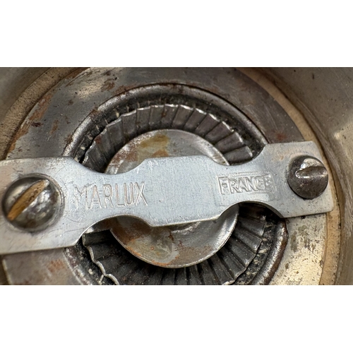 564 - A silver-plated pepper grinder with chased decoration. Est. £20 - £30.