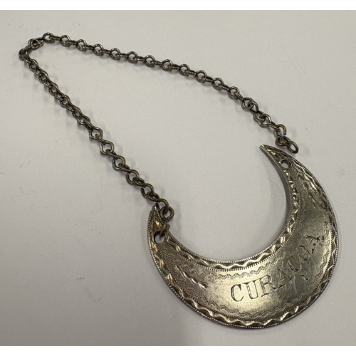 571 - A crescent-shaped early 19th Century silver wine label for 'Curacoa'. Approx. 10 grams. Est. £40 - £... 