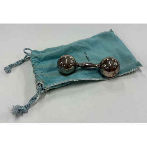 579 - A baby's silver rattle contained within original pouch. By Tiffany & Co. Approx. 53 grams. Est. £50 ... 