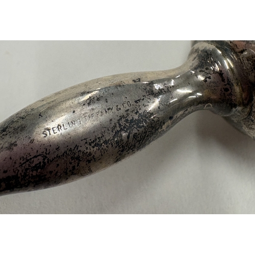 579 - A baby's silver rattle contained within original pouch. By Tiffany & Co. Approx. 53 grams. Est. £50 ... 