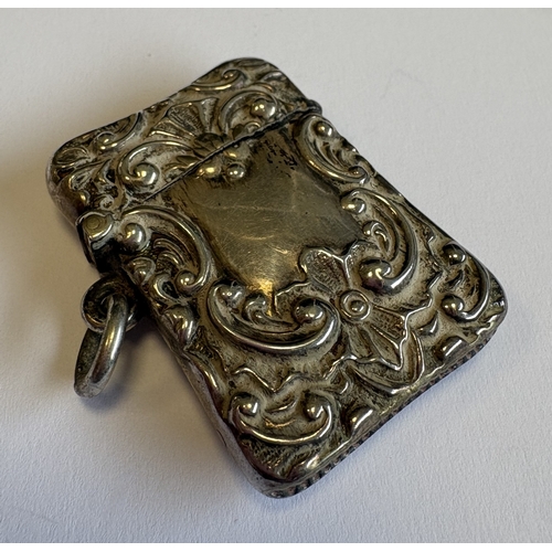 582 - A chased silver vesta case with loop top. Approx. 20 grams. Est. £20 - £30.