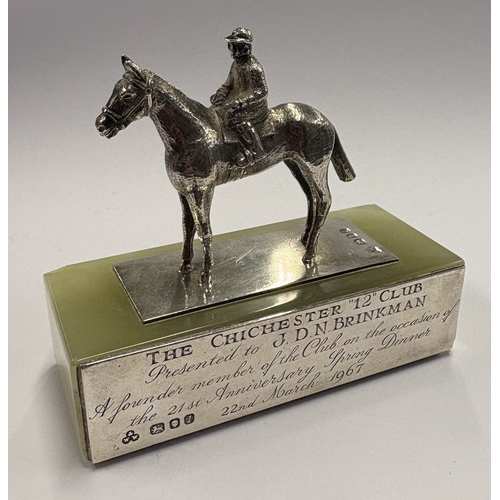 584 - A silver figure of a jockey on rectangular base inscribed 'The Chichester 12', presented to 'JDM Bri... 