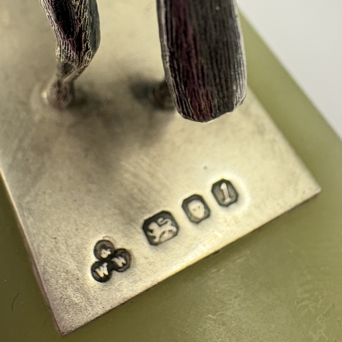 584 - A silver figure of a jockey on rectangular base inscribed 'The Chichester 12', presented to 'JDM Bri... 