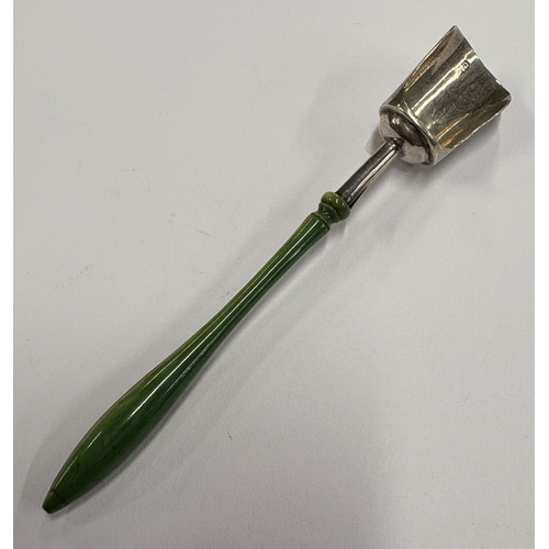 585 - A novelty Victorian silver caddy scoop with green coral handle. Maker's mark only, by Cocks & Bettri... 