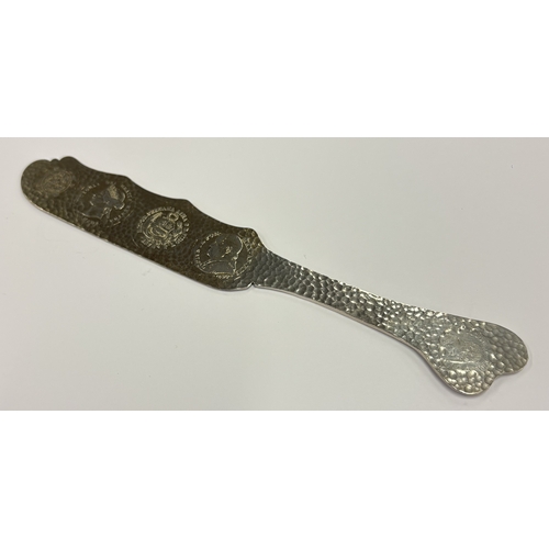 591 - A novelty American silver letter opener inset with five coins. Approx. 70 grams. Est. £200 - £300.