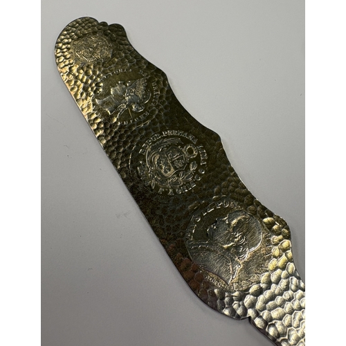 591 - A novelty American silver letter opener inset with five coins. Approx. 70 grams. Est. £200 - £300.